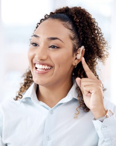 Happy, deaf and black woman with cochlear implant in office for communication, translation and spee